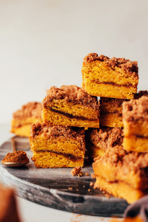 Stack of squares of pumpkin coffee cake with a pumpkin spice swirl and streusel topping