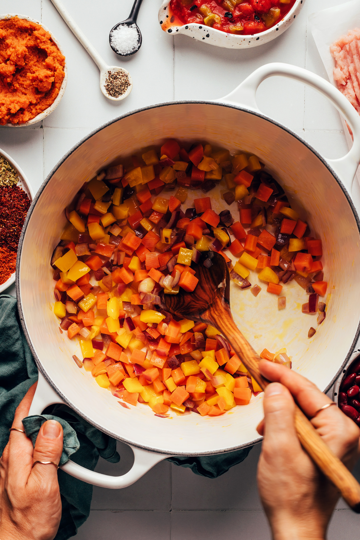 Sautéing onions and carrots in a pot