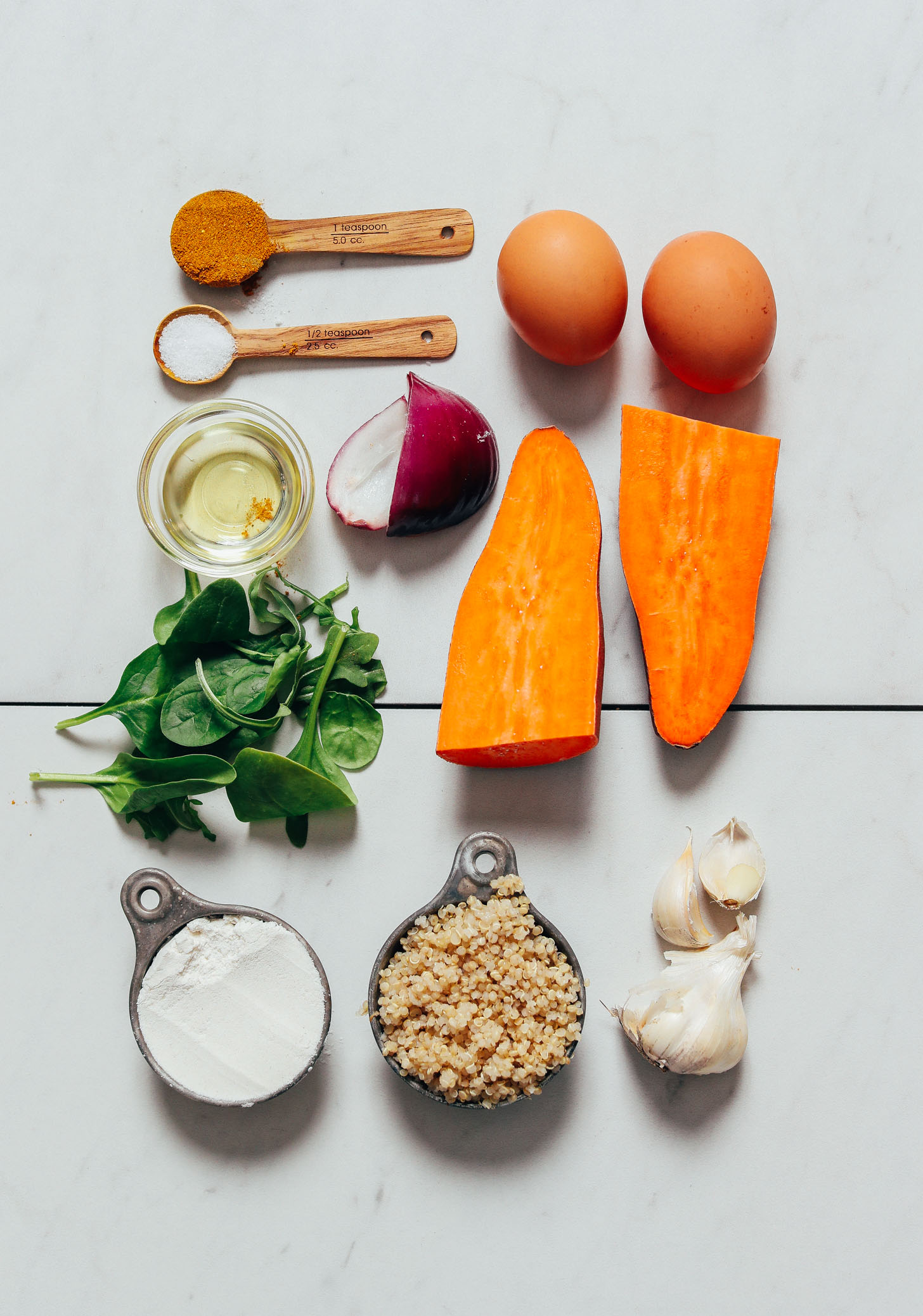 Spinach, quinoa, eggs, sweet potato, garlic, and other ingredients for making our Quinoa Sweet Potato Fritters recipe