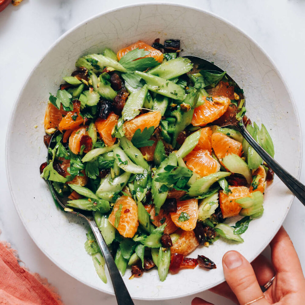 Holding a bowl of fresh celery salad