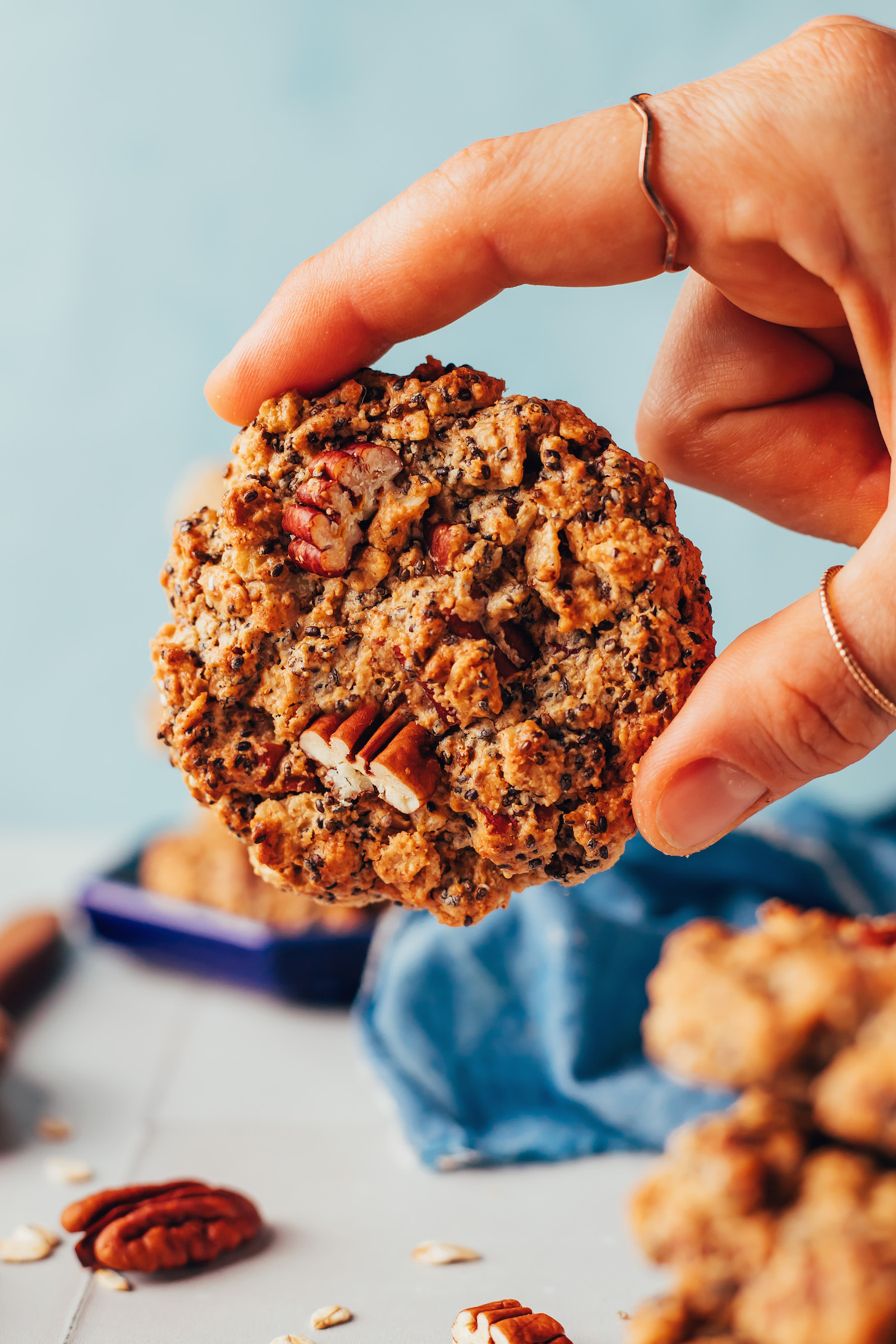 Holding a gluten-free vegan chai-spiced oatmeal cookie with the top facing the camera