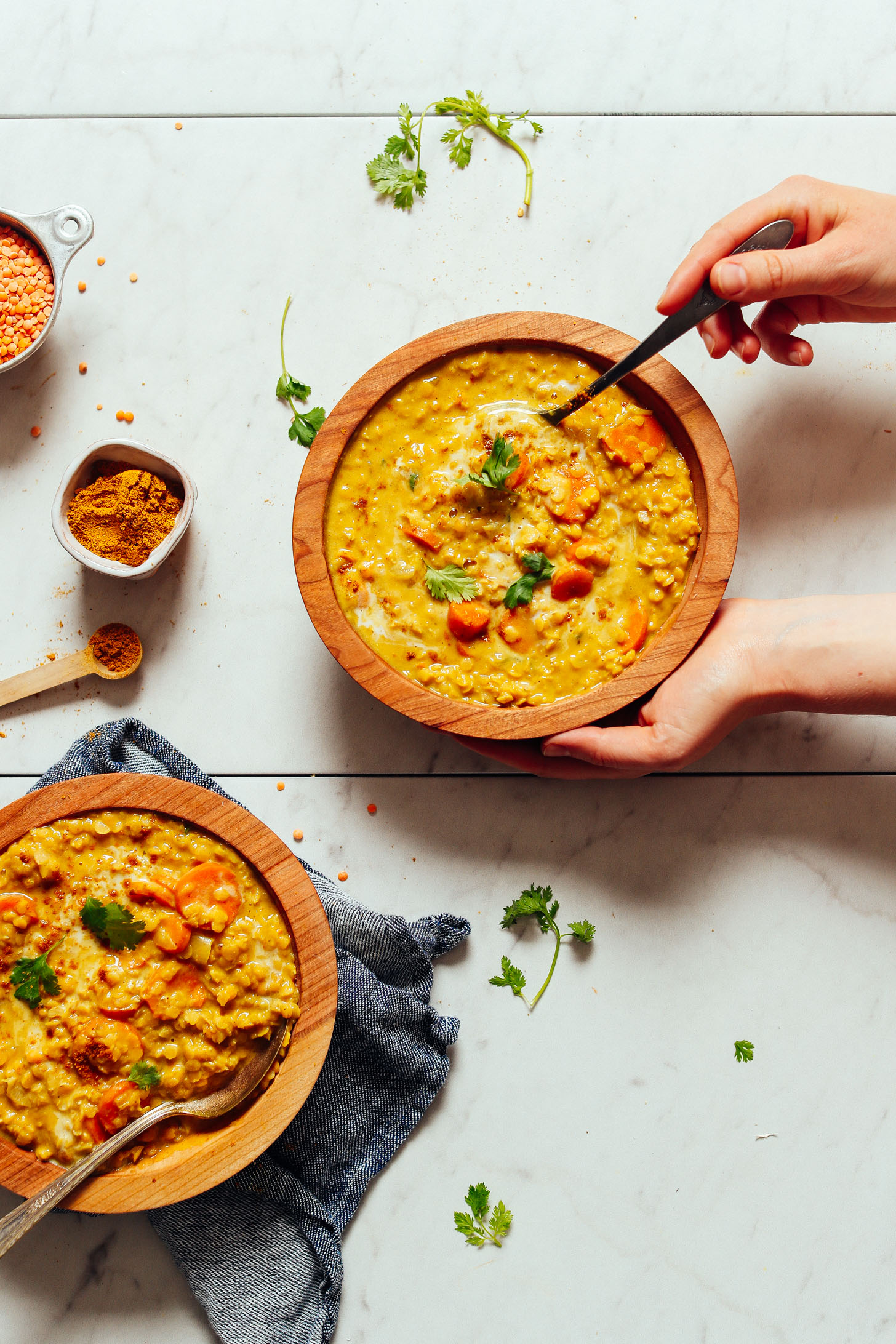 Two bowls of Golden Curried Lentil Soup topped with cilantro