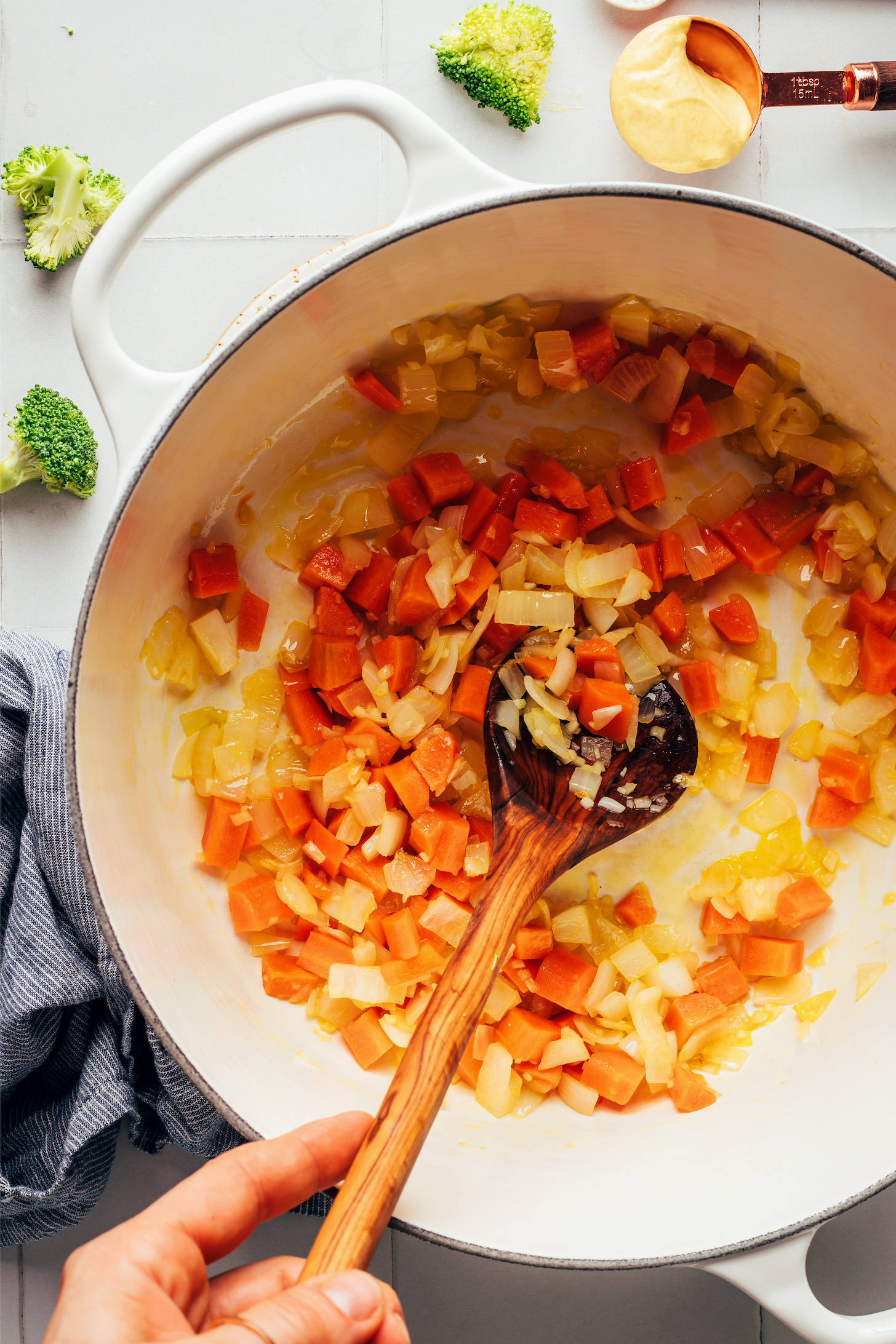 Sautéing carrots, onion, and garlic in a Dutch oven