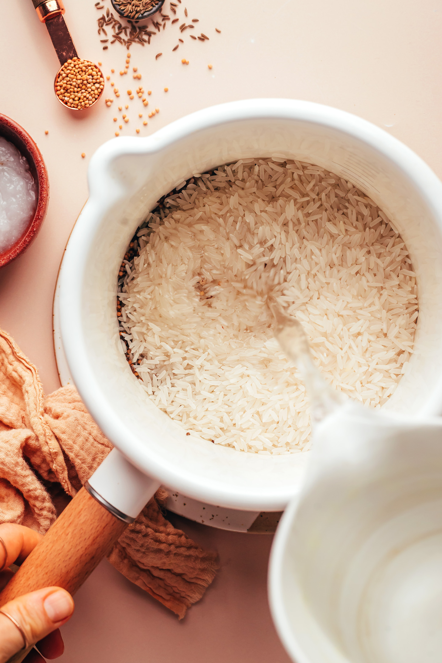 Pouring water into a saucepan of rice