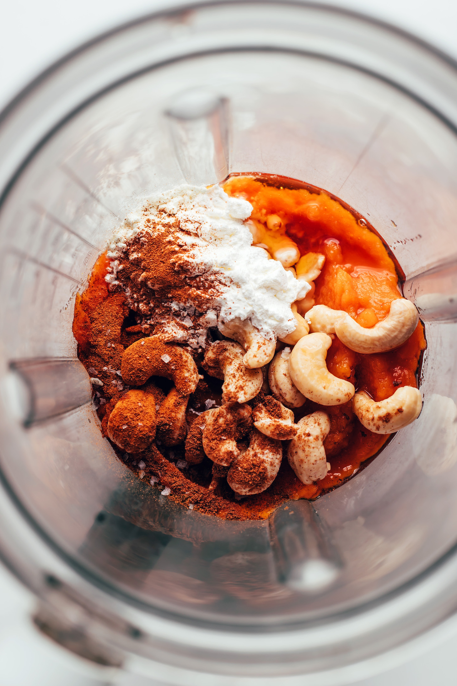 Blender with sweet potato purée, cashews, spices, and maple syrup