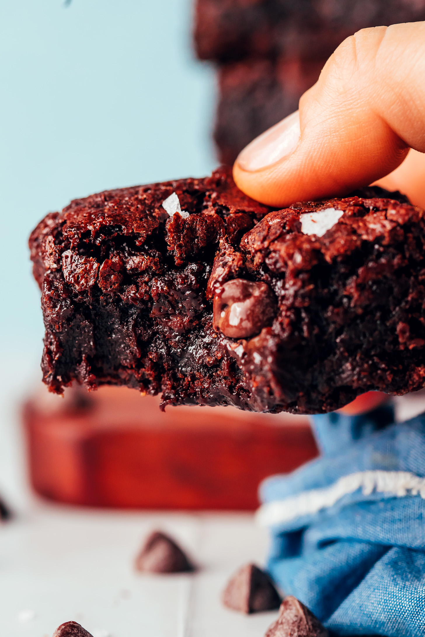 Close up shot of a super fudgy vegan gluten-free brownie topped with flaky salt