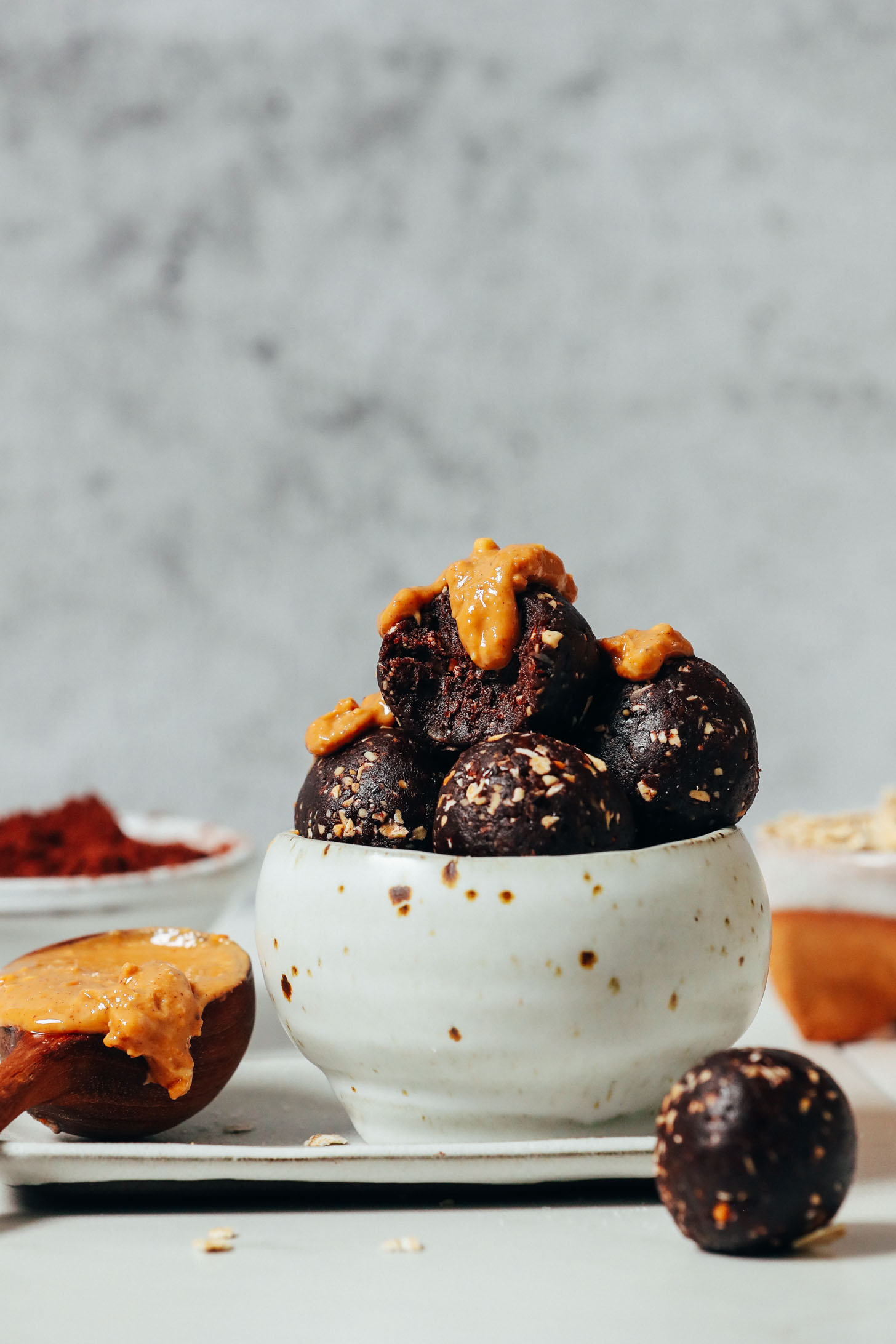 Bowl of Chocolate Cookie Energy Bites topped with peanut butter