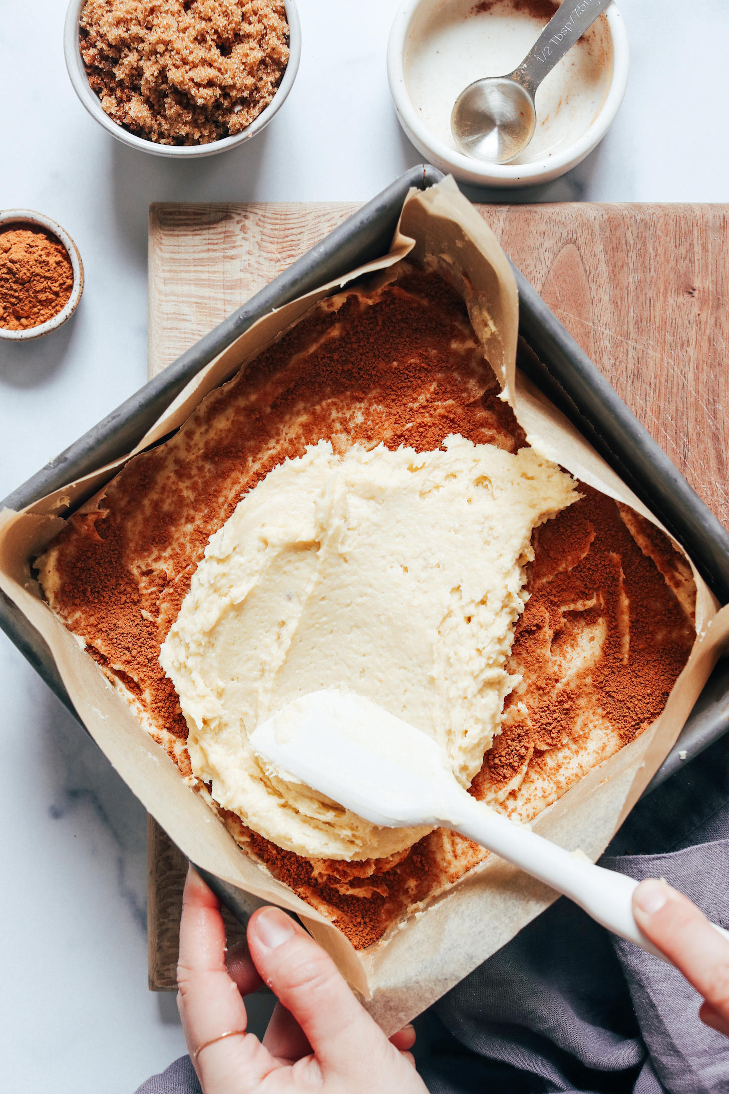 Spreading batter over a cinnamon sugar swirl layer