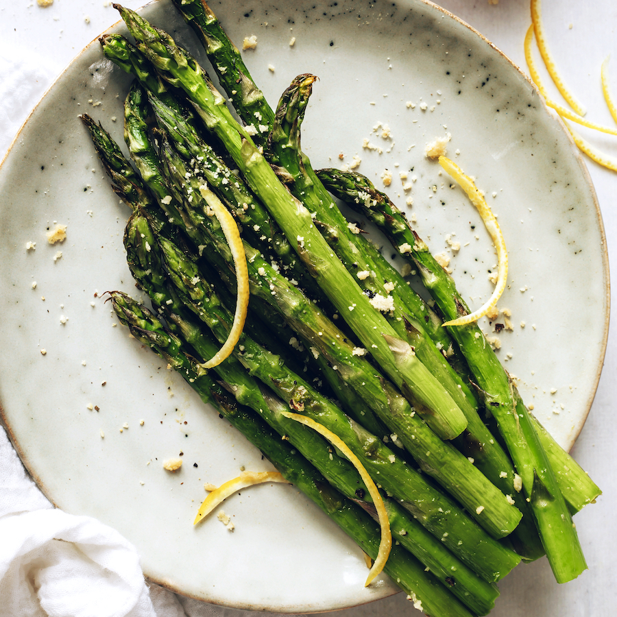 Small plate of roasted asparagus with lemon and vegan parmesan