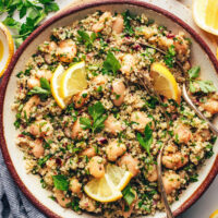 Spoon in a bowl of white bean quinoa salad