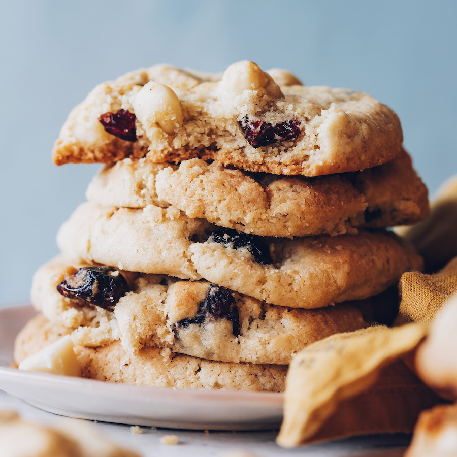 Plate with a stack of cranberry macadamia nut cookies