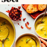 Bowls and a pot of vegan broccoli cheddar soup