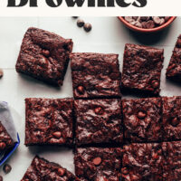 Overhead photo of a batch of brownies with text reading vegan + gluten-free fudgy crackly top brownies