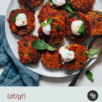 Plate of Crispy Quinoa Sweet Potato Fritters topped with dairy-free yogurt