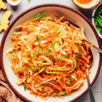 Overhead shot of a bowl of cabbage apple slaw tossed with a Korean-inspired dressing