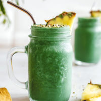 Refreshing green lemonade smoothies with pineapple and hemp seeds as garnish