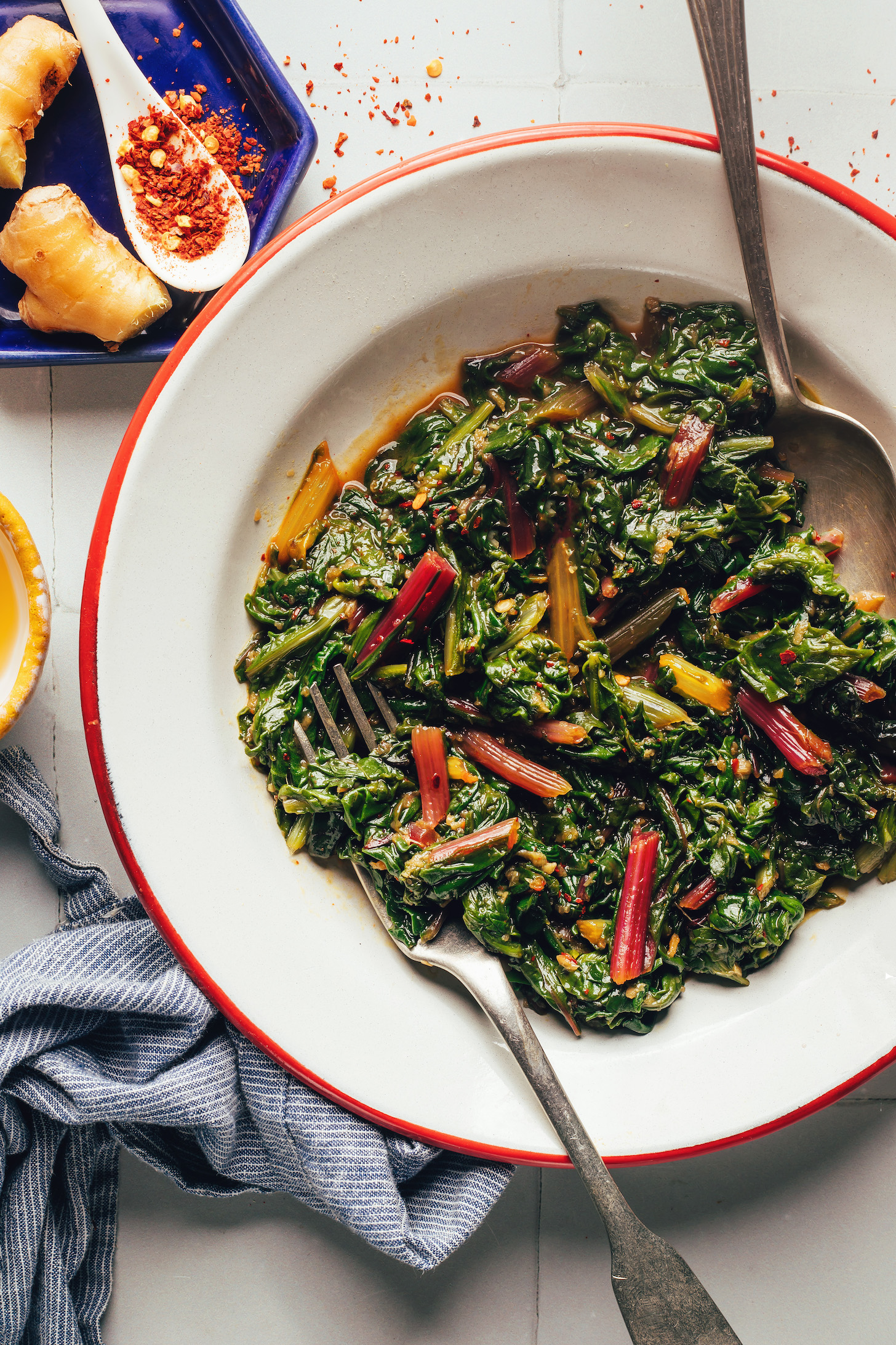 Bowl of sautéed swiss chard seasoned with garlic, sesame, and tamari