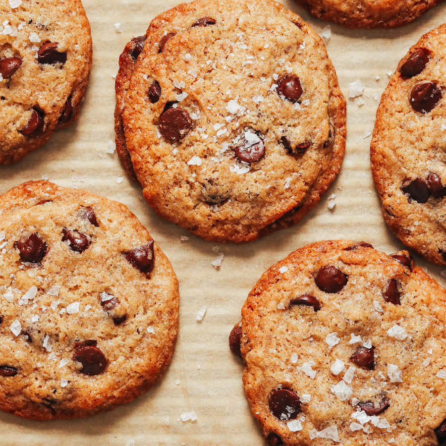 Close up shot of vegan chocolate chip cookies topped with flaky salt