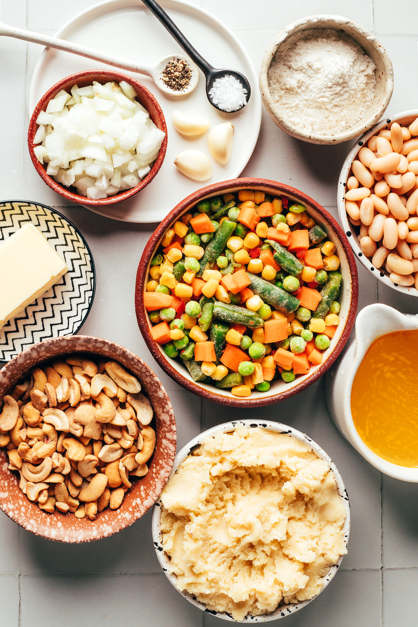 Gluten-free biscuit dough, cashews, vegan butter, mixed frozen vegetables, onion, garlic, salt, pepper, gluten-free flour blend, white beans, and vegetable broth