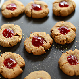 Baking sheet filled with Vegan PB&J Thumbprint Cookies