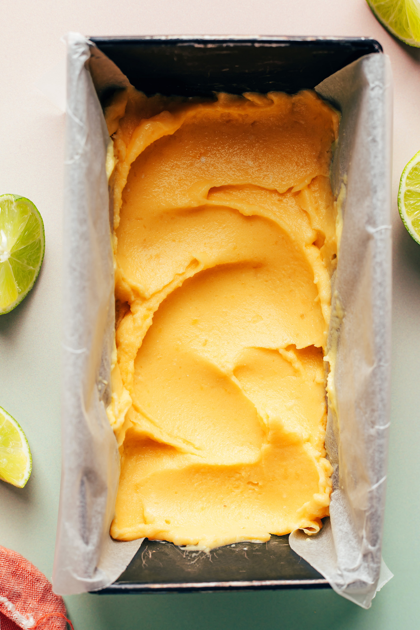 Loaf pan with the mango pineapple layer of rainbow sherbet